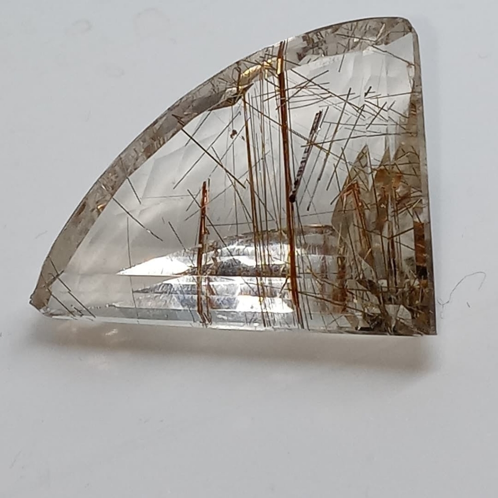 A dazzling freeform rutilated quartz cabochon